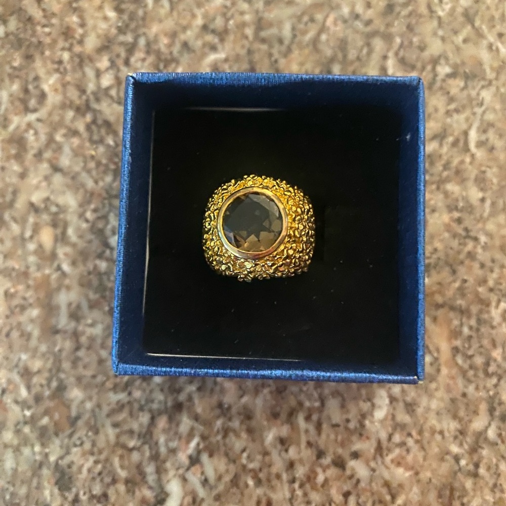 Gold ring with purple stone